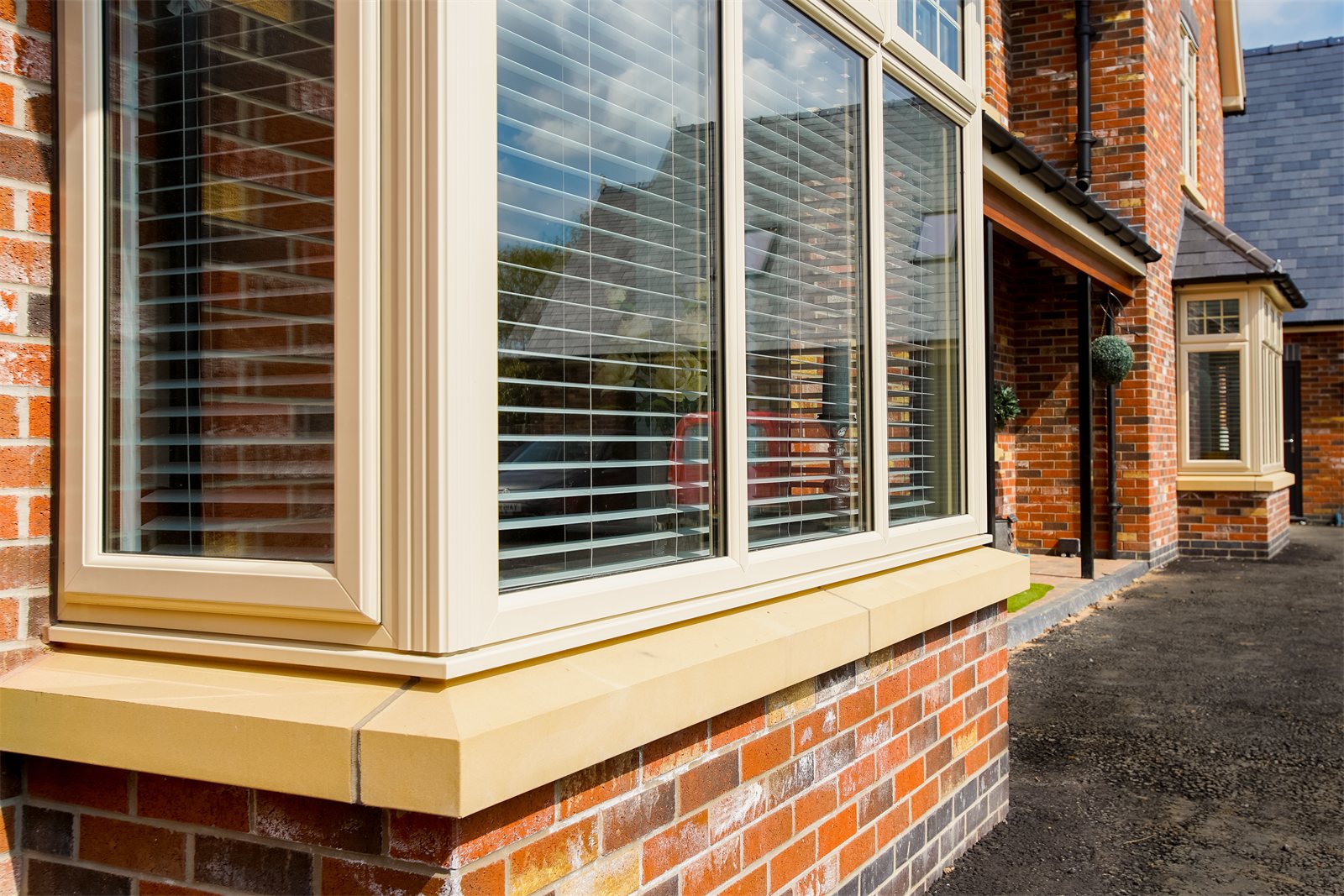 Cream uPVC bay window on a new build (product photo)
