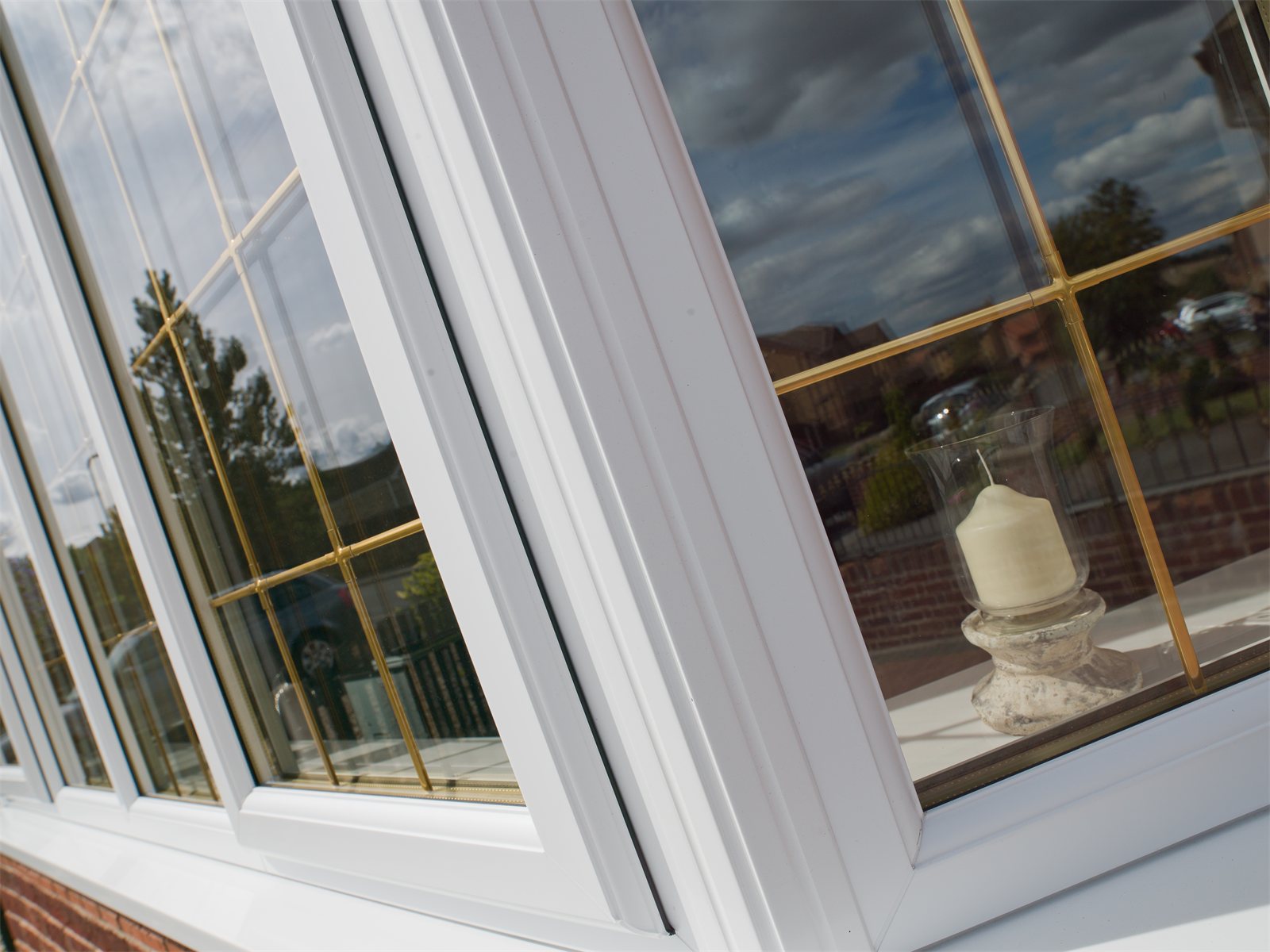 Close-up of a bay window with brass Georgian bars (product photo)