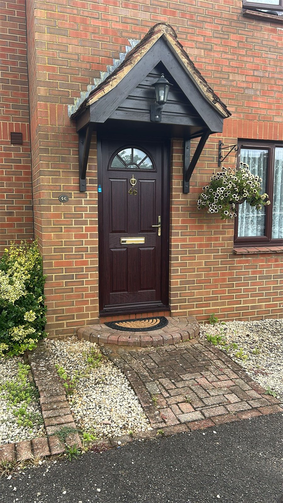 Rosewood composite door under a canopy, London, fitted by Termopane Windows