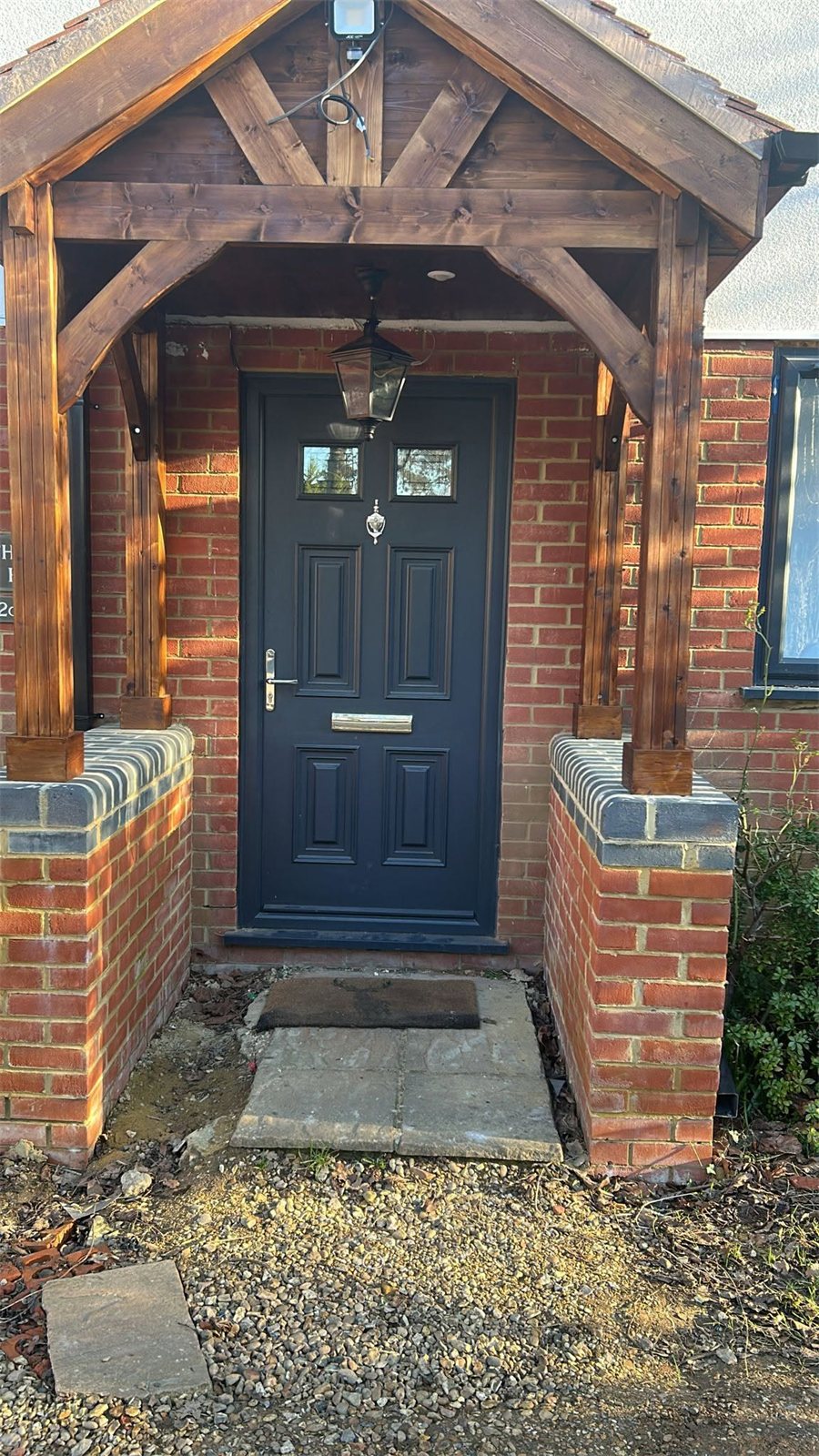 Navy composite door under an oak porch, London, fitted by Termopane Windows