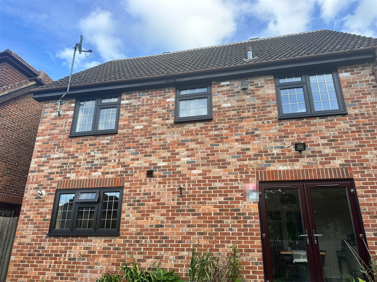 Black flush sash windows across the back of a house, St Albans, fitted by Termopane Windows