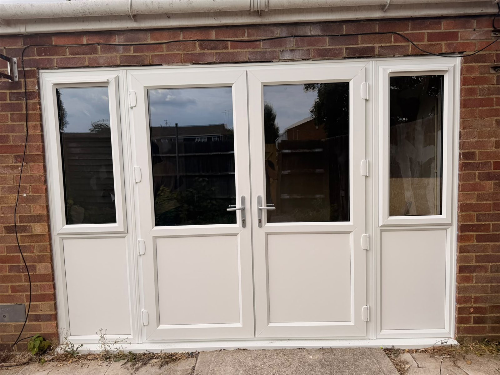 White uPVC French doors with side panels, fitted by Termopane Windows
