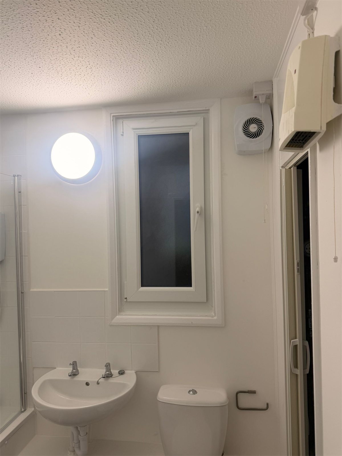 Narrow tilt and turn window in a bathroom, London, fitted by Termopane Windows