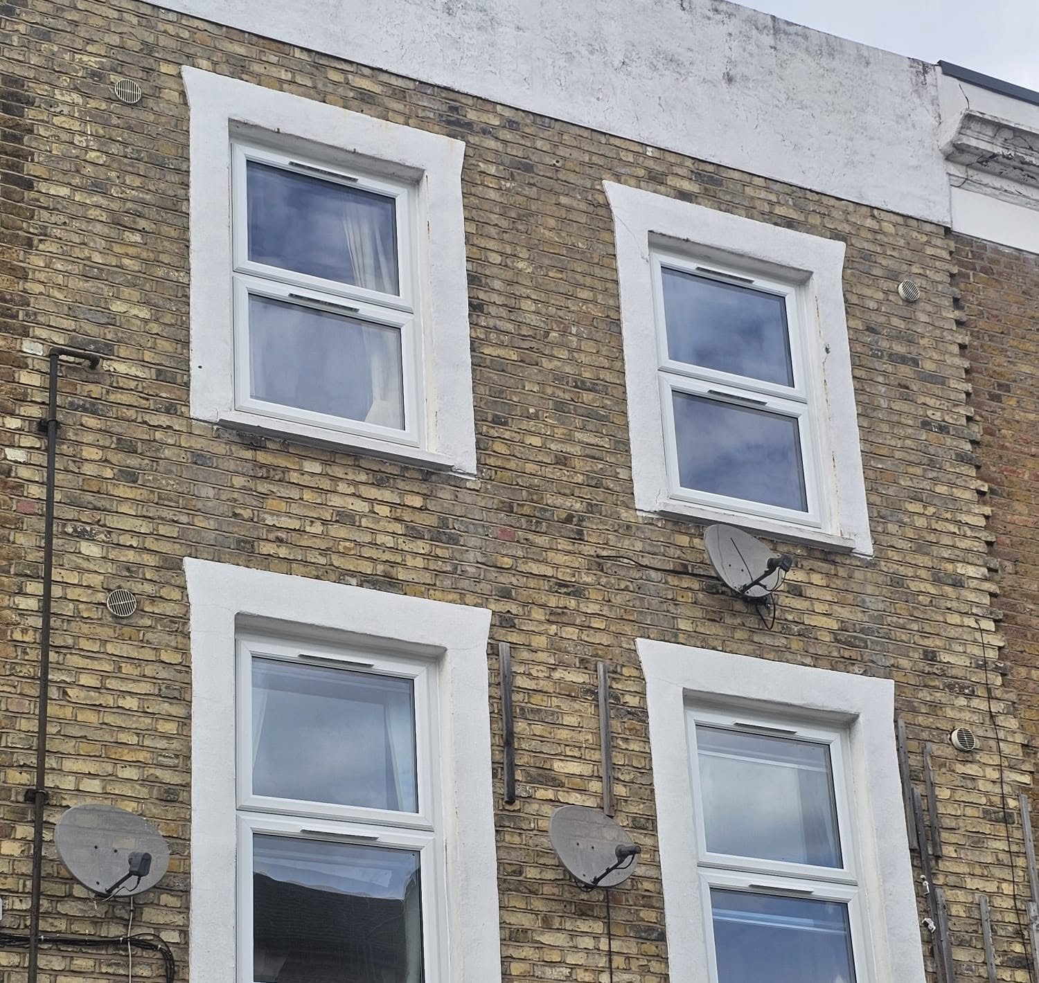 White uPVC casement windows on a three-storey terrace, London, fitted by Termopane Windows
