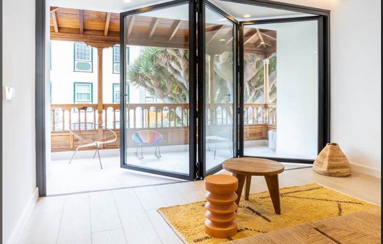 Aluminium bifold doors opening onto a balcony (product photo)